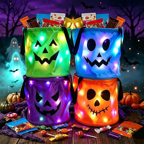 Four colored light-up Halloween treat bags in a styled scene; candy and props excluded